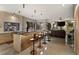 Entertain in this large living room boasting a bar, recessed lighting, and views of the outdoor water feature at 49 Osprey Point Dr, Osprey, FL 34229