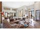 Bright, open living space with leather sectional, high ceilings, and natural light at 49 Osprey Point Dr, Osprey, FL 34229