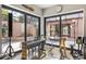 Bright music room with large windows and a beautiful courtyard view at 49 Osprey Point Dr, Osprey, FL 34229