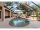 Beautiful screened pool area with waterfall feature and ample seating at 49 Osprey Point Dr, Osprey, FL 34229