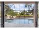Enjoy this screened-in backyard that features a pool, lush landscaping, and expansive views of the water at 49 Osprey Point Dr, Osprey, FL 34229