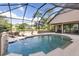 Screened in pool area with water feature, tanning chairs, and view of the lake at 49 Osprey Point Dr, Osprey, FL 34229
