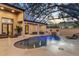 Backyard pool and entertainment area with an enclosed lanai offering comfortable seating and a private oasis at 49 Osprey Point Dr, Osprey, FL 34229