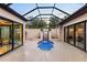 Stunning outdoor oasis with a unique water feature, enclosed by glass, and surrounded by multiple access points at 49 Osprey Point Dr, Osprey, FL 34229