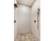 Modern shower with stylish fixtures and unique pebble flooring at 49 Osprey Point Dr, Osprey, FL 34229