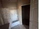 Bathroom featuring tiled walls, shower and tub combo, decorative shower curtain, and walk-in closet at 5560 Rosehill Rd # 105, Sarasota, FL 34233