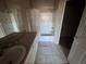Tiled bathroom featuring a shower and tub combo, decorative shower curtain, vanity and tile flooring at 5560 Rosehill Rd # 105, Sarasota, FL 34233