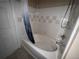 Tiled bathroom featuring a shower and tub combo with blue shower curtain at 5560 Rosehill Rd # 105, Sarasota, FL 34233