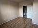 Neutral bedroom with wood flooring and a doorway leading to a bathroom at 5560 Rosehill Rd # 105, Sarasota, FL 34233