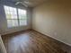 Bedroom featuring hardwood floors and a large window offering lots of natural light at 5560 Rosehill Rd # 105, Sarasota, FL 34233