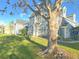 Charming two-story blue townhome with a lush green lawn and beautiful curb appeal at 5560 Rosehill Rd # 105, Sarasota, FL 34233