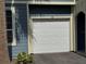 Attached one car garage with white door at 5560 Rosehill Rd # 105, Sarasota, FL 34233