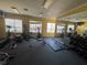Community gym with exercise equipment and mirrors at 5560 Rosehill Rd # 105, Sarasota, FL 34233