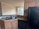 Kitchen area with a sink, cabinets, and modern appliances for meal preparations at 5560 Rosehill Rd # 105, Sarasota, FL 34233