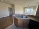 Open-concept kitchen featuring wood cabinets, neutral countertops, and a view to the living space at 5560 Rosehill Rd # 105, Sarasota, FL 34233