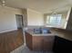 Open-concept kitchen featuring wood cabinets, neutral countertops, and a view to the living space at 5560 Rosehill Rd # 105, Sarasota, FL 34233
