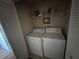 Laundry room featuring a full size washer and dryer with wire shelving for storage at 5560 Rosehill Rd # 105, Sarasota, FL 34233