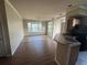 Open-concept living room and kitchen area with hardwood floors and natural light at 5560 Rosehill Rd # 105, Sarasota, FL 34233