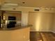 Spacious living room with breakfast bar, modern track lighting, and neutral wall colors at 5560 Rosehill Rd # 105, Sarasota, FL 34233