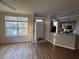 Open concept living room and kitchen featuring laminate floors, a view and bright natural light at 5560 Rosehill Rd # 105, Sarasota, FL 34233