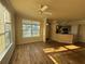 Spacious living room with ceiling fan and laminate flooring at 5560 Rosehill Rd # 105, Sarasota, FL 34233