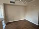 An empty living room with wood-look floors and neutral colored walls at 5560 Rosehill Rd # 105, Sarasota, FL 34233