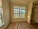 Cozy living room with laminate floors and a window view of the community pond at 5560 Rosehill Rd # 105, Sarasota, FL 34233