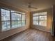 Well-lit living room with updated flooring and large windows overlooking a pond and neighborhood at 5560 Rosehill Rd # 105, Sarasota, FL 34233