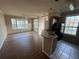 Open-concept living room and kitchen area with hardwood floors and natural light at 5560 Rosehill Rd # 105, Sarasota, FL 34233
