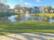 Scenic view of the community pond featuring a fountain and lush green surroundings at 5560 Rosehill Rd # 105, Sarasota, FL 34233
