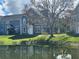 Lovely two-story blue townhouse sits lakeside with mature landscaping at 5560 Rosehill Rd # 105, Sarasota, FL 34233