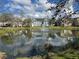 Scenic view of the community pond featuring a fountain and lush green surroundings at 5560 Rosehill Rd # 105, Sarasota, FL 34233