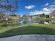 Picturesque pond with a fountain and mature landscaping in a residential neighborhood at 5560 Rosehill Rd # 105, Sarasota, FL 34233