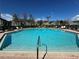 Community pool surrounded by lounge chairs and well-maintained landscaping at 5560 Rosehill Rd # 105, Sarasota, FL 34233