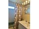 Modest bathroom featuring a sink, a curtain, and a shower/tub combination at 5791 Holiday Park Blvd, North Port, FL 34287