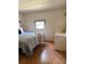Neat bedroom offers a comfortable bed, a well-lit window, and a dresser for ample storage at 5791 Holiday Park Blvd, North Port, FL 34287