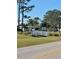 Charming community view with green lawns, trees, and pedestrian bridge, a peaceful setting for residents at 5791 Holiday Park Blvd, North Port, FL 34287