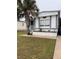 Charming single-story home with well-maintained lawn and mature palm tree in the front yard at 5791 Holiday Park Blvd, North Port, FL 34287