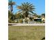 Lush community garden with palm trees, bench seating and manicured landscaping, ideal for relaxation at 5791 Holiday Park Blvd, North Port, FL 34287