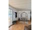 Cozy living room featuring hardwood floors, a large cabinet and access to a bright sunroom at 5791 Holiday Park Blvd, North Port, FL 34287