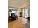 Inviting living room featuring hardwood floors, comfortable seating, and access to a bright sunroom at 5791 Holiday Park Blvd, North Port, FL 34287