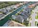 Stunning aerial view of waterfront property featuring a private pool, boat dock, and lush tropical landscaping at 581 Mast Dr, Bradenton, FL 34208