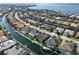 Breathtaking aerial view of the waterfront property surrounded by canals and beautiful homes in a desirable community at 581 Mast Dr, Bradenton, FL 34208