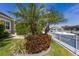 Beautifully landscaped backyard with lush greenery and a waterfront view with boat, offering a serene and private outdoor space at 581 Mast Dr, Bradenton, FL 34208
