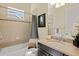 Full bathroom with tub and shower combo, dark vanity, and modern tile details at 581 Mast Dr, Bradenton, FL 34208