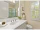 Bathroom featuring a sink with vanity and a window with white shutters at 581 Mast Dr, Bradenton, FL 34208