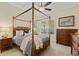Bedroom featuring a four-poster bed, side tables, chest of drawers and window at 581 Mast Dr, Bradenton, FL 34208