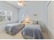 Bedroom featuring blue decor, carpeted floors, and a large window with shutters at 581 Mast Dr, Bradenton, FL 34208