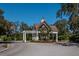 Charming community entrance with pergola, mature landscaping, and well-maintained grounds at 581 Mast Dr, Bradenton, FL 34208