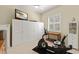 Bright exercise room with ample storage, stationary bike, and neutral carpet at 581 Mast Dr, Bradenton, FL 34208